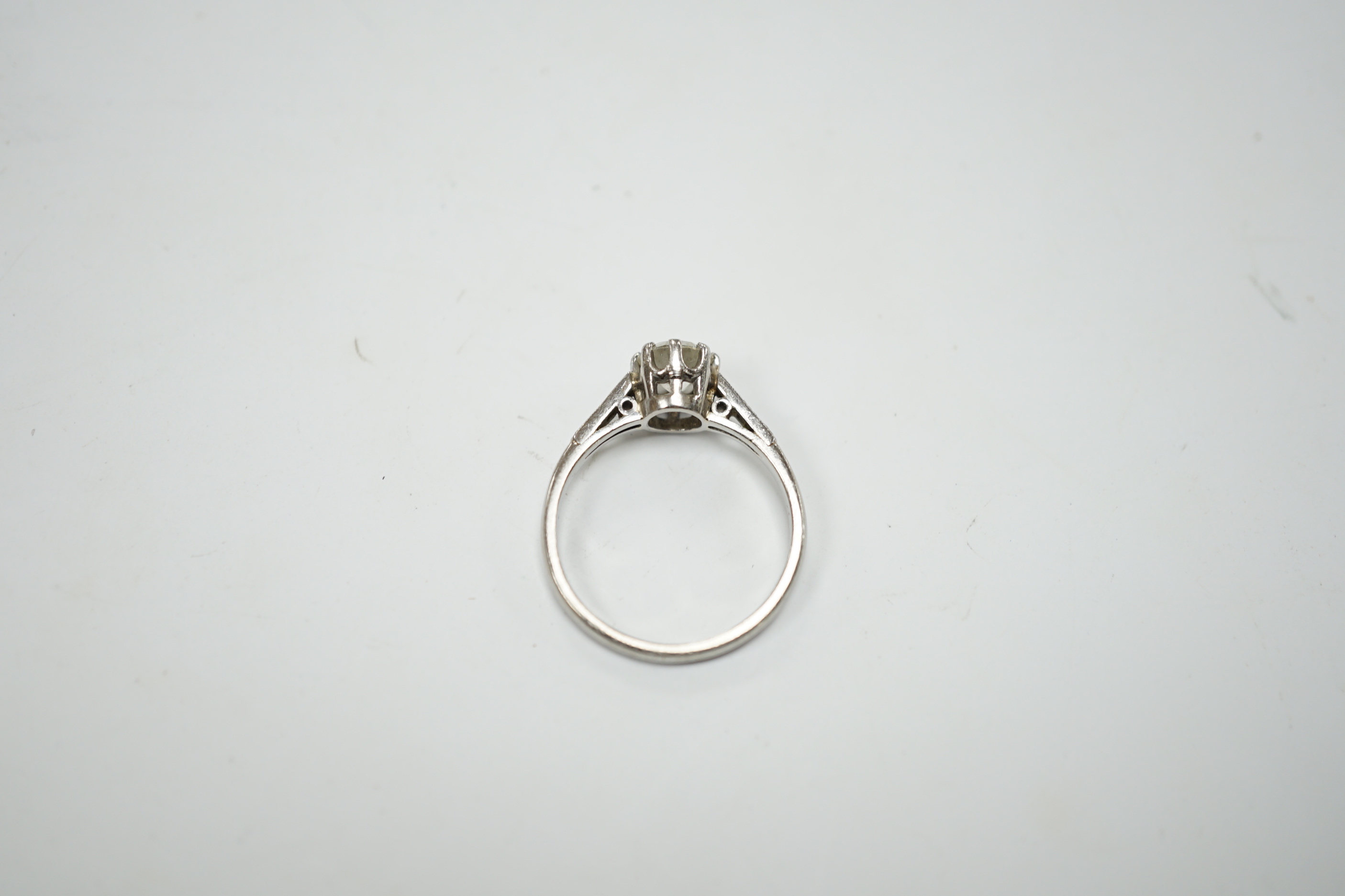 A platinum and single stone diamond set ring, with six stone diamond chip set shoulders, size P, gross weight 4.5 grams